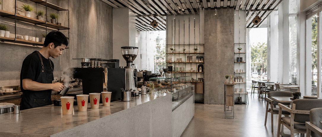 the espresso bar in action, wide shot, warm and inviting